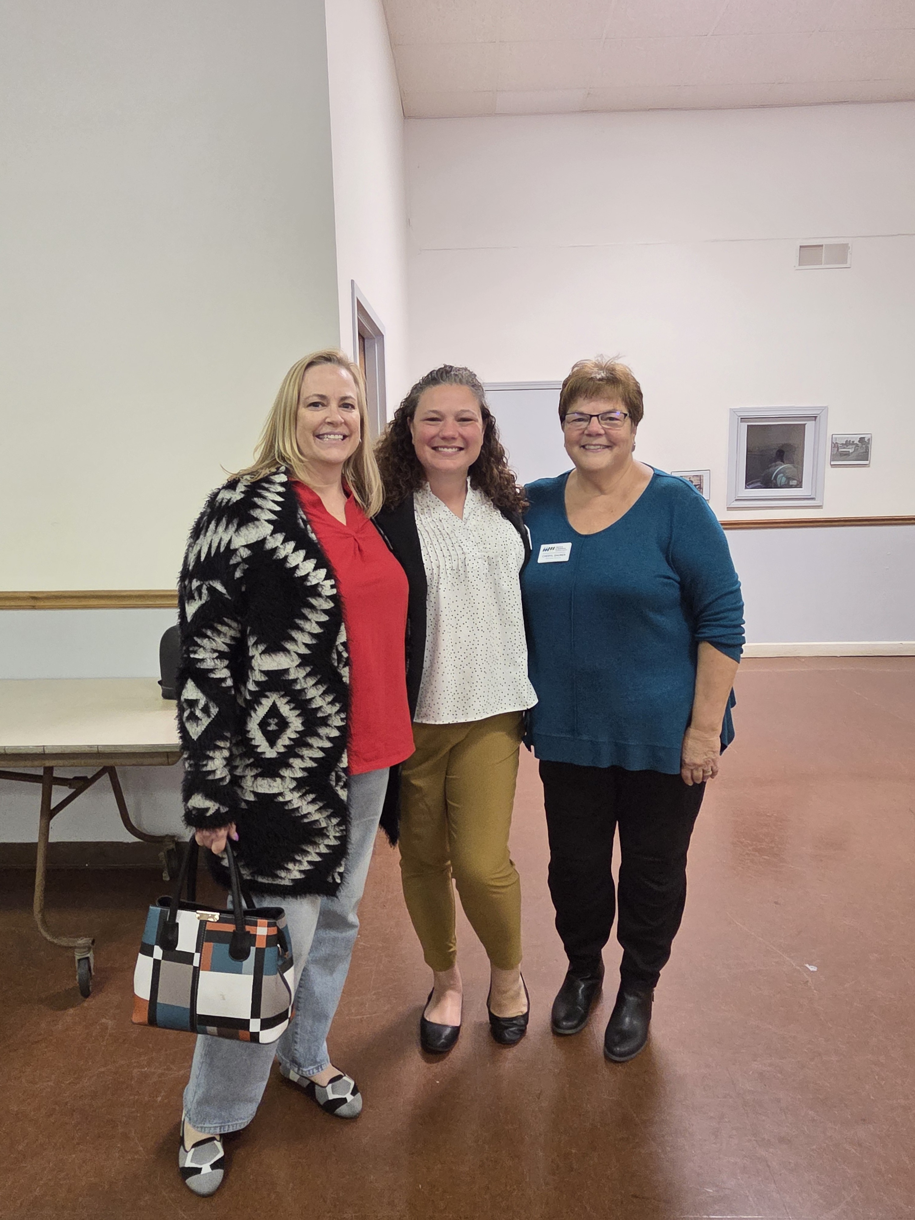 Three Meals on Wheels supporters posing together at a community fundraiser event