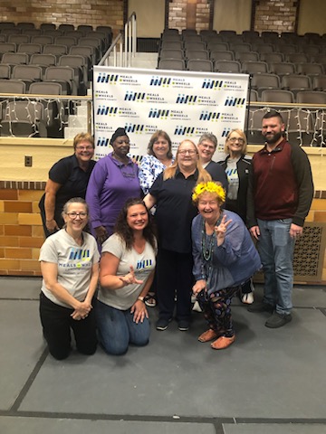 Meals on Wheels LaPorte County team group photo at an event with MOW banner backdrop