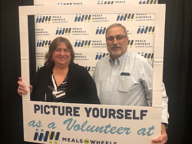Supporters posing in the Picture Yourself as a Volunteer photo booth at the annual gala