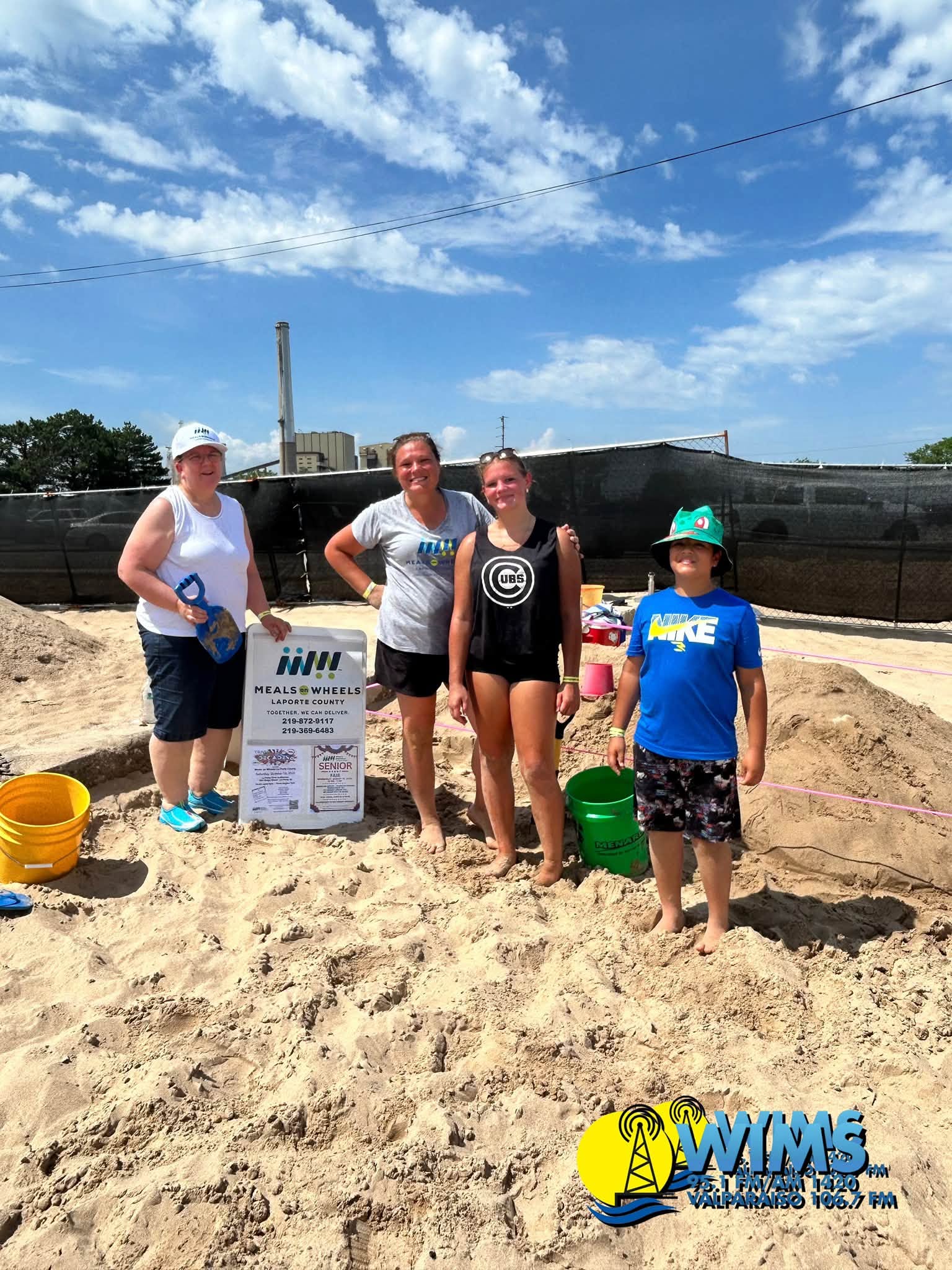 The Meals on Wheels LaPorte County team posing with their sand sculpture at the festival