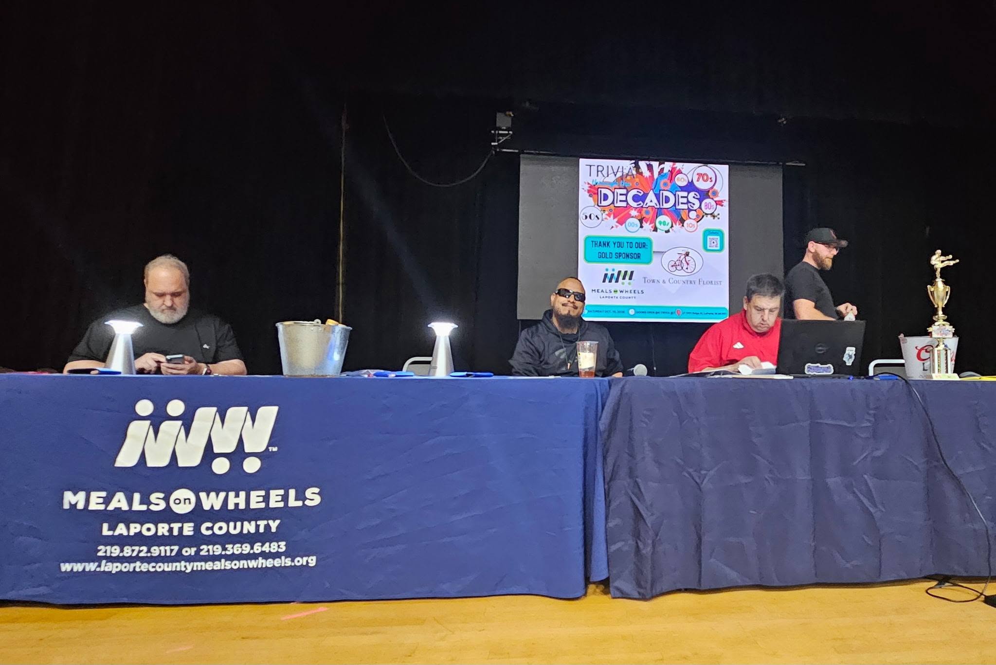 The MOW stage table with Trivia Through the Decades branding